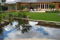 Looking across pond and lawn to house